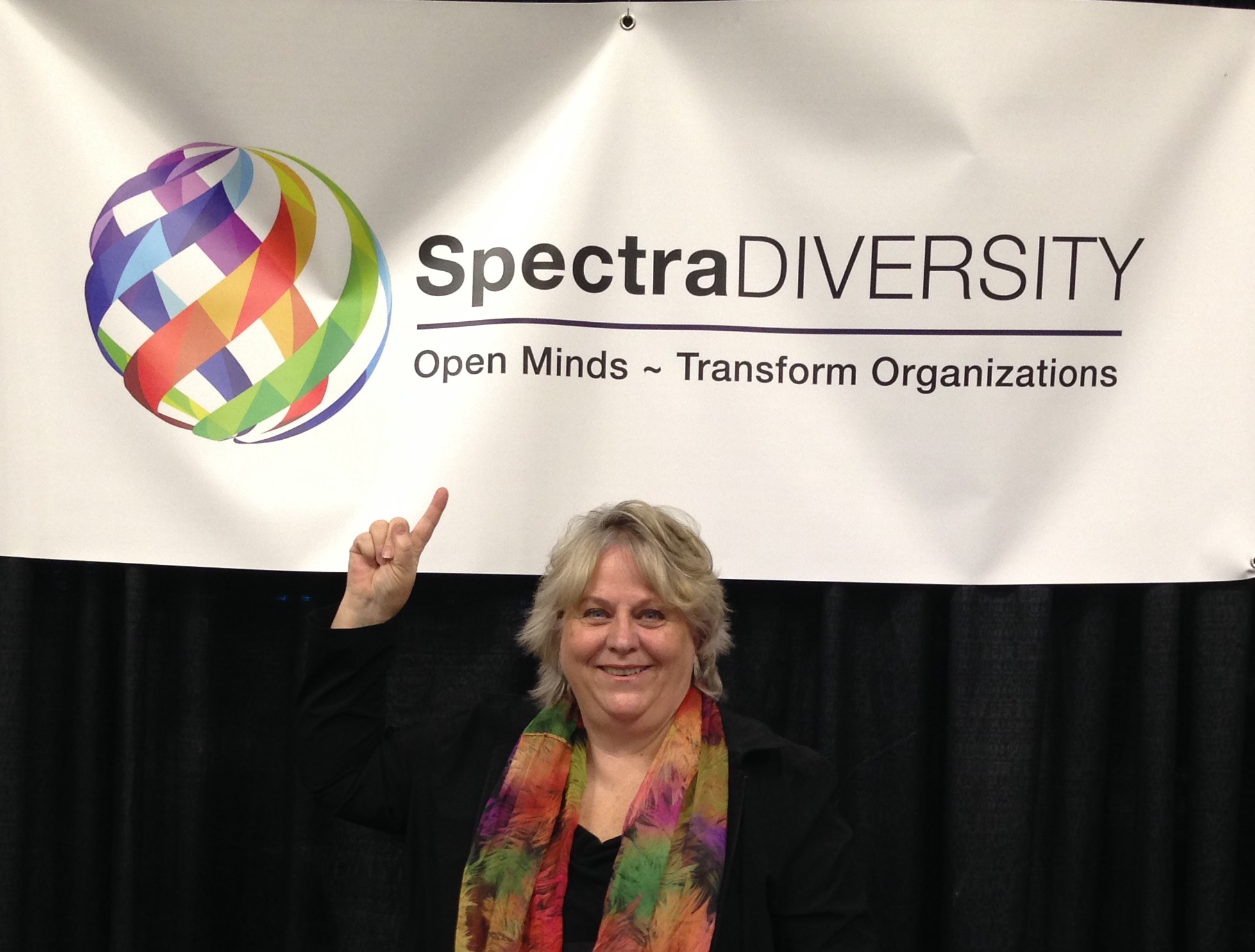 Chris Jones pointing to Spectra Diversity. Open Minds, Transform Organizations.