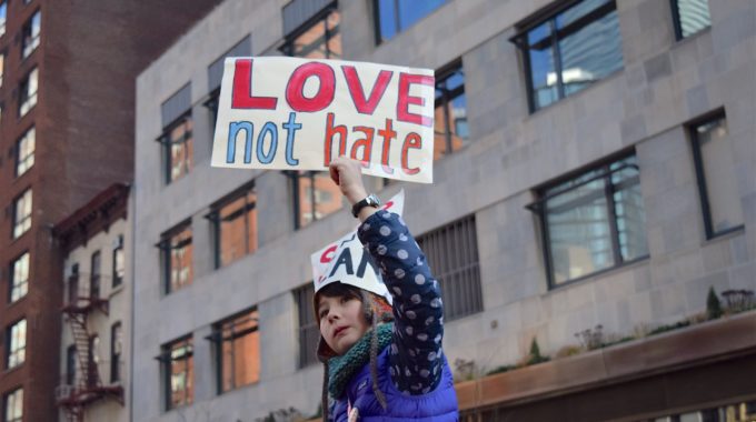 Women's Equality Is Still A Struggle As A Young Girl Holds A Sign That Says Love Not Hate